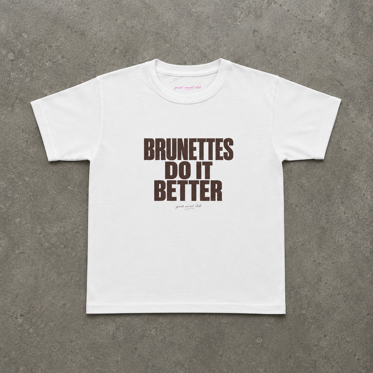 Brunettes Do It Better Baby Tee in White, flat lay