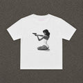 Hands-Up Baby Tee in white, flat lay with a black and white kneeling figure print