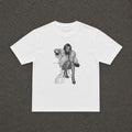 Moss Baby Tee in white, flat lay with a black and white fur coat portrait print
